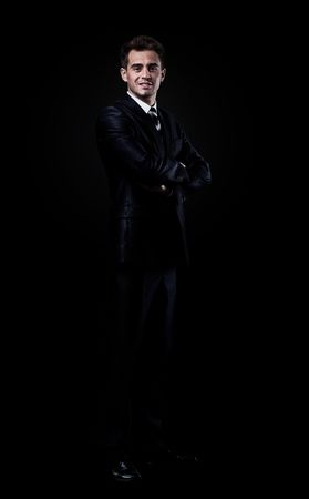78326345-businessman-isolated-over-black-background